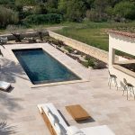Terrace with swimming pool tiled with the Tiber collection, travertine look