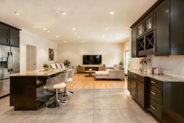 open-plan kitchen with wood effect tiles and concrete effect tiles